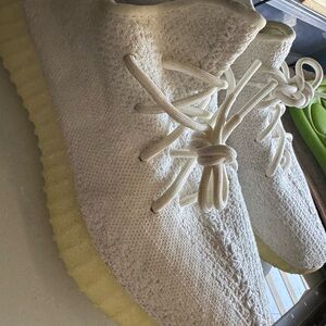 Adidas Yeezy Boost 350 V2 in the "Cream White" or "Triple White" colorway.